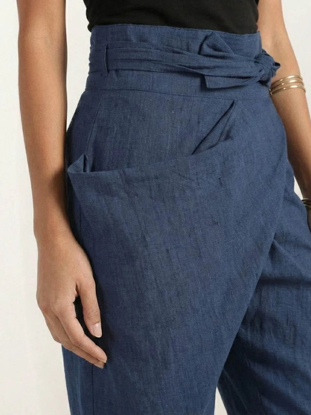 Gray wrap front tapered pants on model, standing full-length view