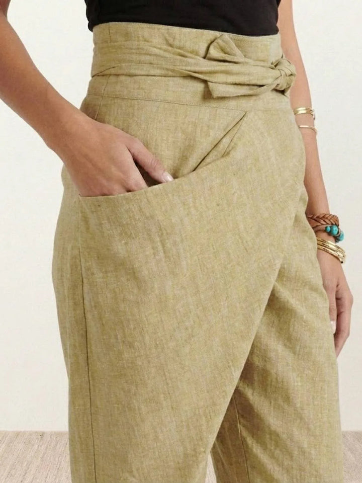 Gray wrap front tapered pants on model, standing styled view