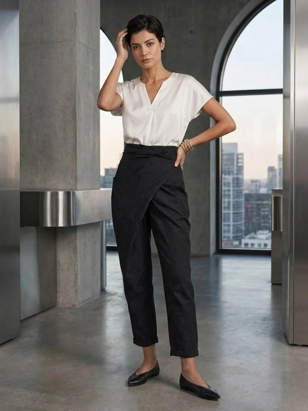 Gray wrap front tapered pants on model, standing full-length pose