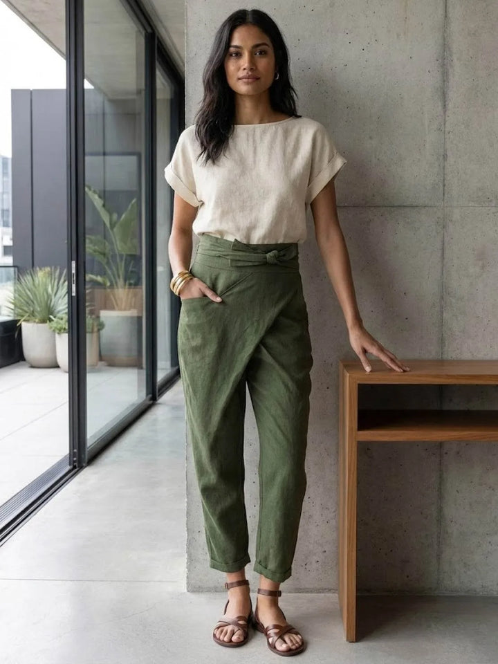 Gray wrap front tapered pants on model, standing relaxed pose