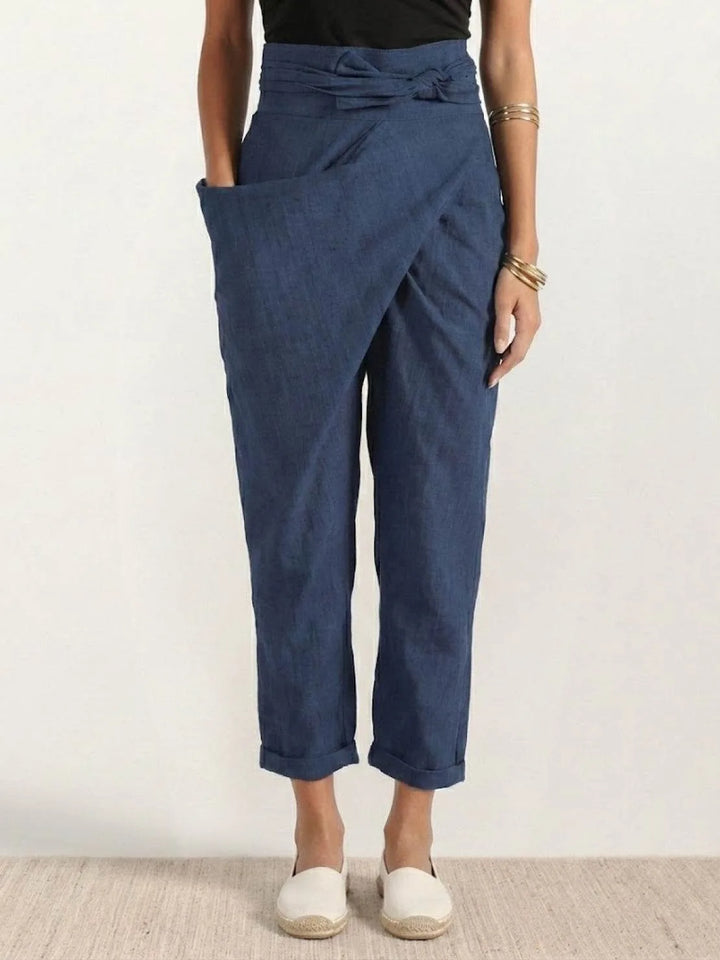 Navy blue wrap front tapered pants on model, full-length view