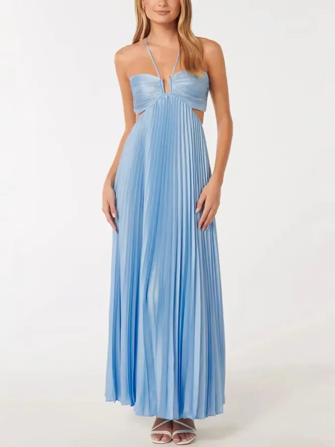 Woman in side profile wearing a blue pleated halter maxi dress