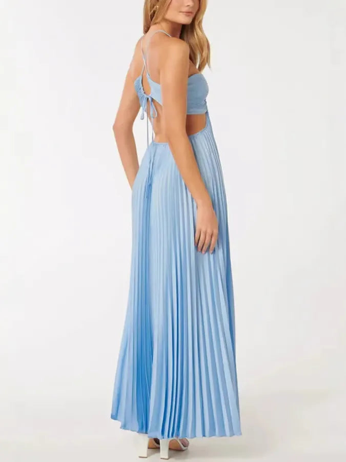 Woman posing in a blue pleated halter maxi dress