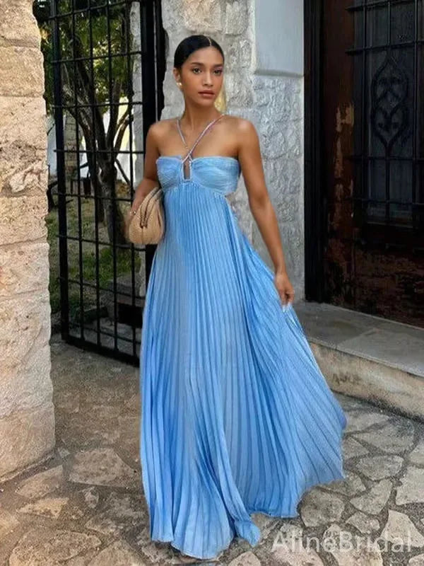 Woman posing in a blue pleated halter maxi dress