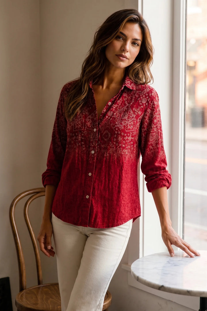 Model wearing red bandana print button-down blouse in lifestyle setting
