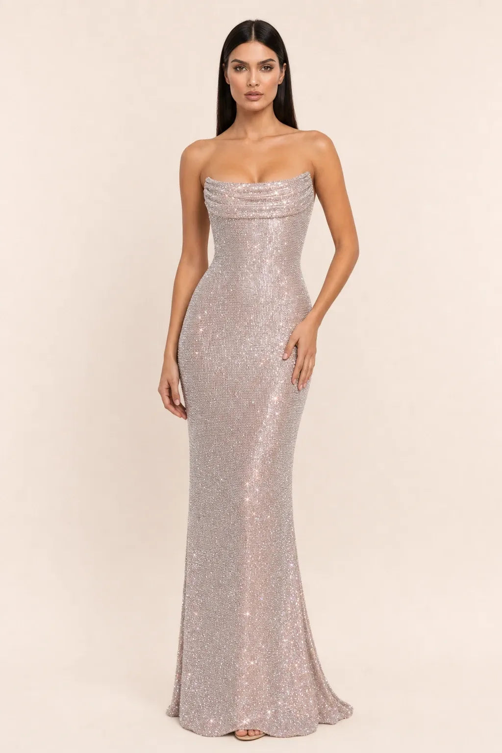 Beige crystal cowl gown on model in contrapposto stance, draped neckline and floor-length silhouette
