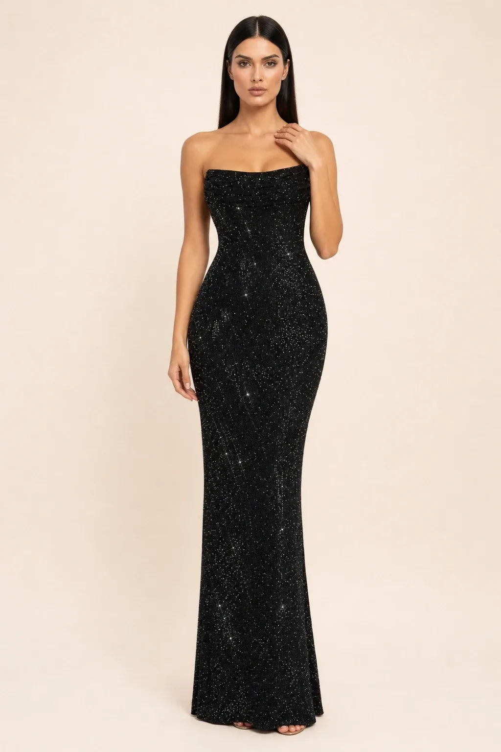 Black crystal cowl gown on model in contrapposto stance, draped neckline and sleek silhouette