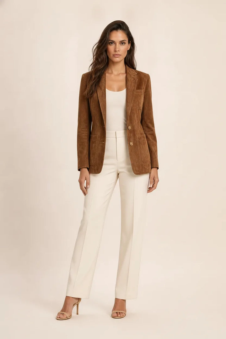 Woman in a brown suede notch lapel blazer posed in front of a storefront
