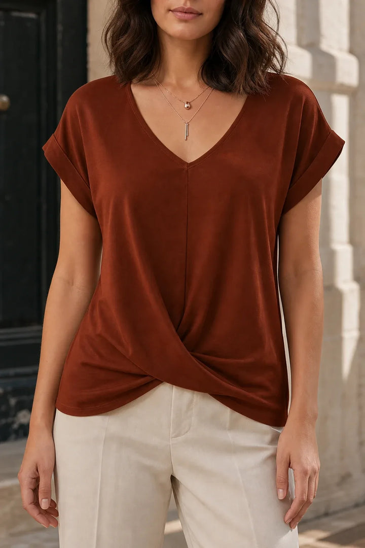 Brown twist-front sleeveless top on model in contrapposto stance