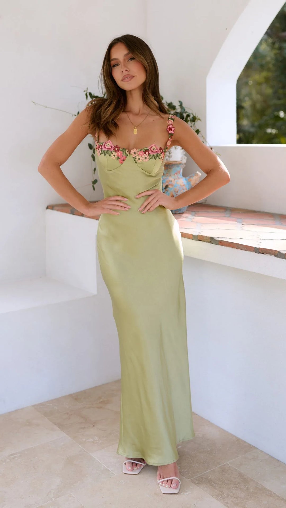 Woman modeling an apple green floral crochet maxi dress in an alternate pose