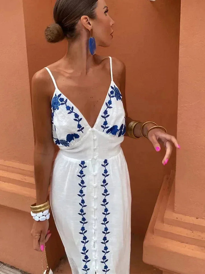 Side view of a woman in a white embroidered maxi dress showing silhouette and sleeve length