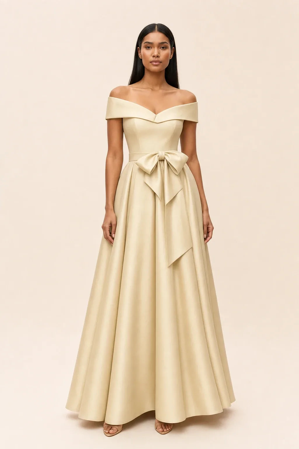 Champagne off-shoulder midi dress with bow detail, model in contrapposto stance
