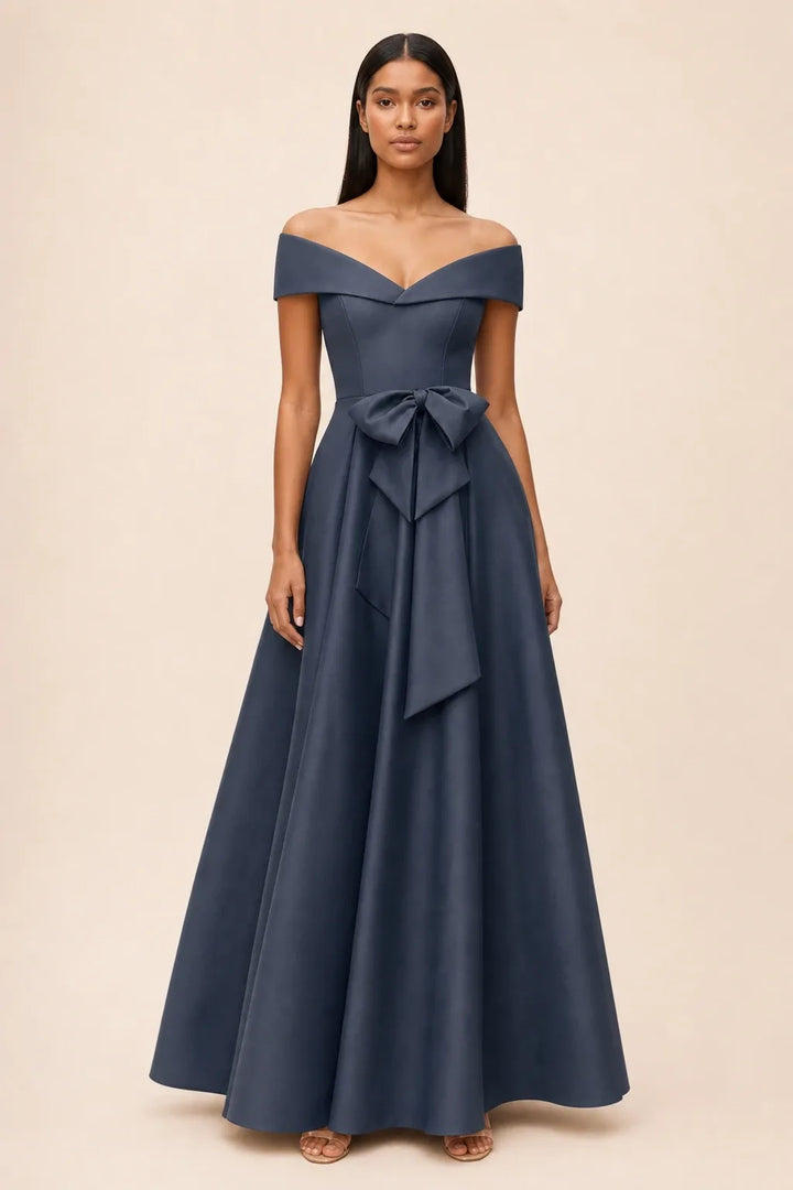 Dark navy off-shoulder midi dress with bow detail, model in contrapposto stance