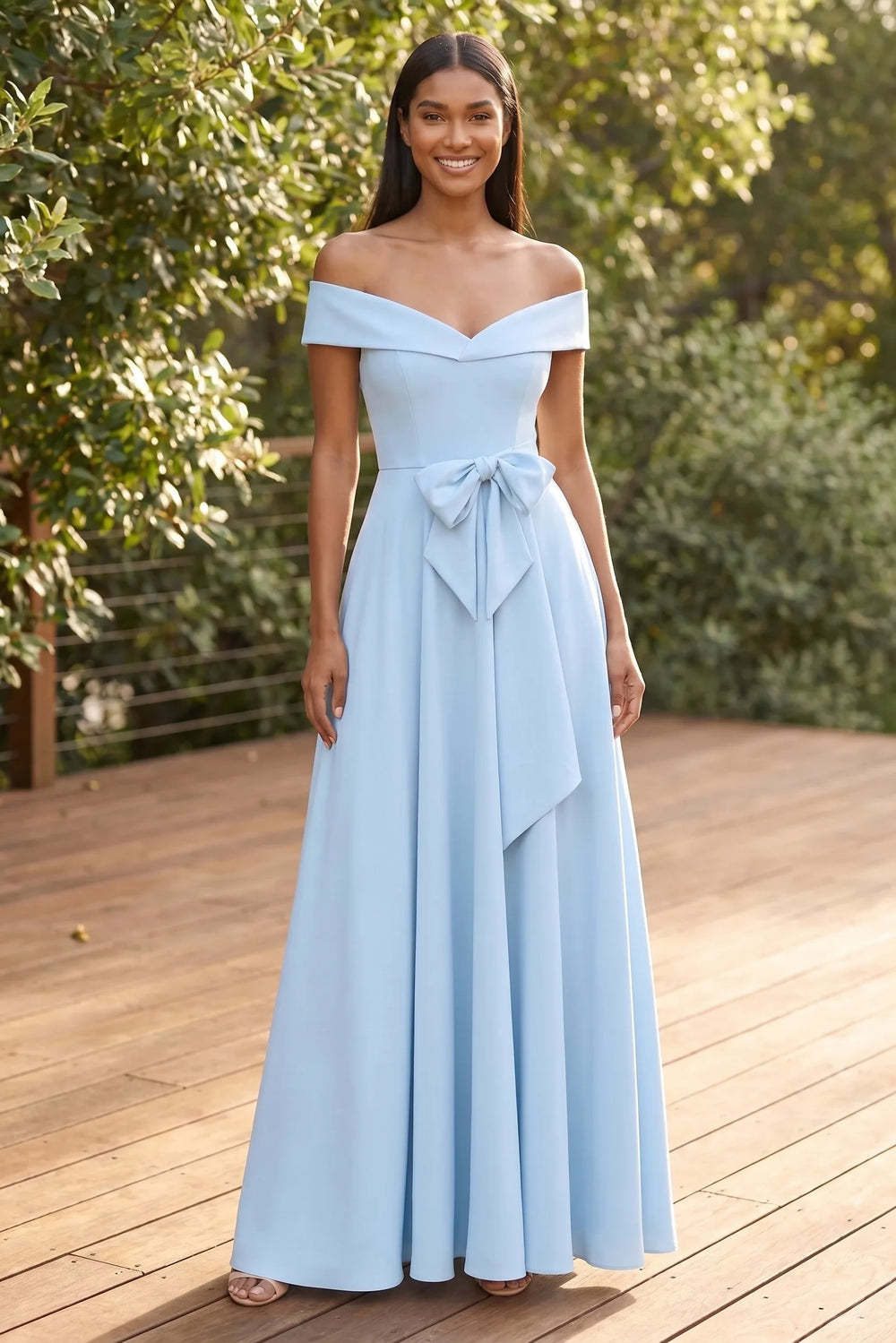 Model wearing light blue off-shoulder bow midi dress in lifestyle setting