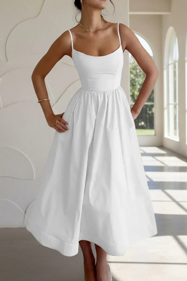 White fit and flare midi dress on model, three-quarter turn