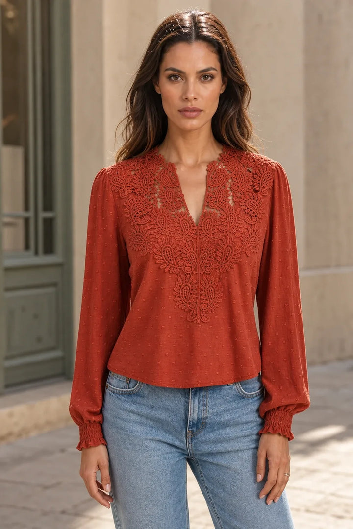Red lace panel blouse on model in contrapposto stance