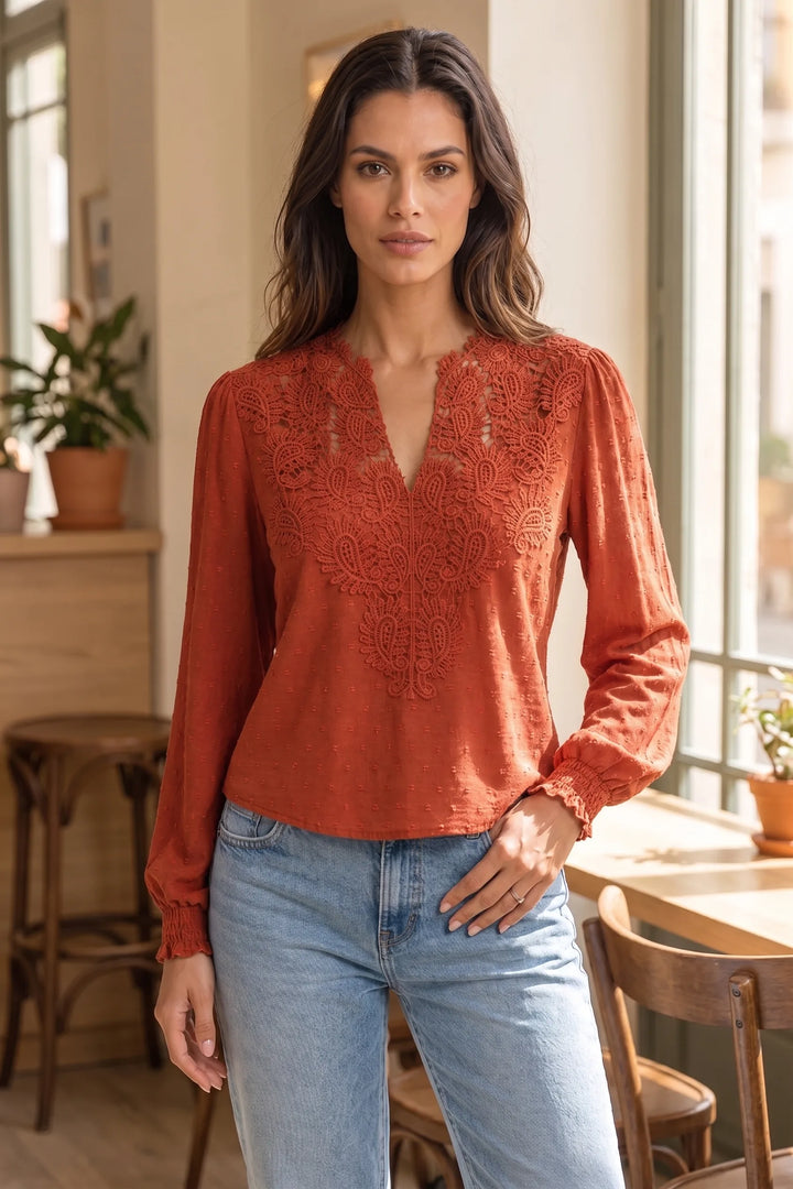 Model wearing red lace panel blouse in lifestyle setting