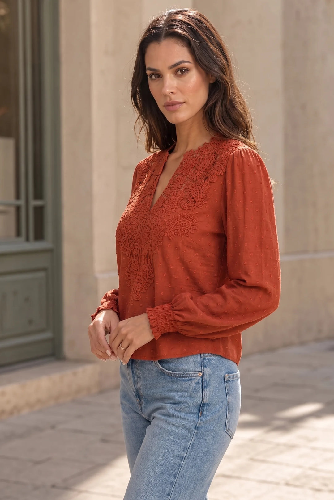 Red lace panel blouse on model in three-quarter turn