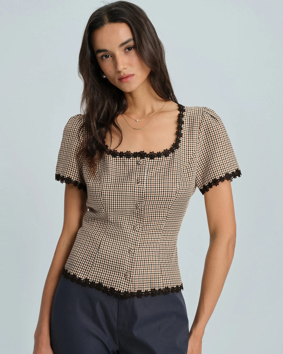 Brown gingham lace-trim top, model viewed from the side