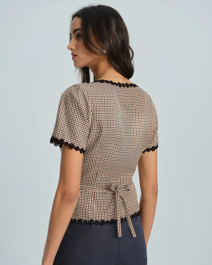 Brown gingham top with lace trim, model standing front-facing