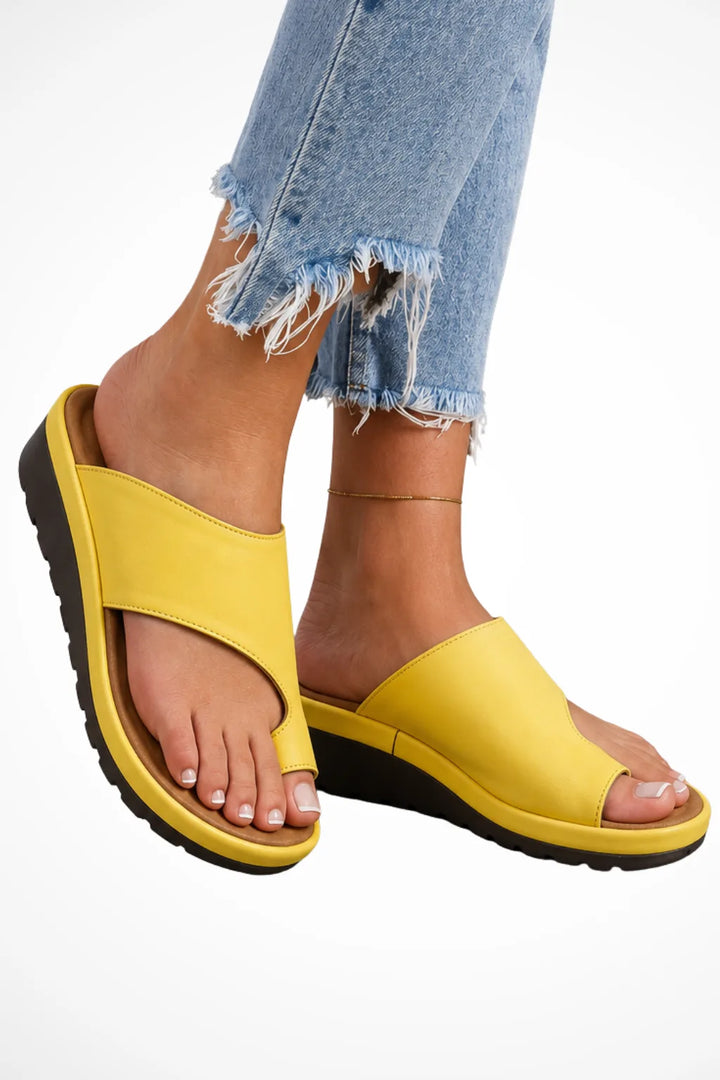 Yellow wedge toe loop sandal, front view