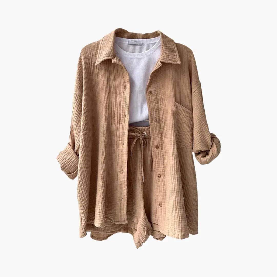 Model at three-quarter turn wearing a beige crinkle shirt and shorts set