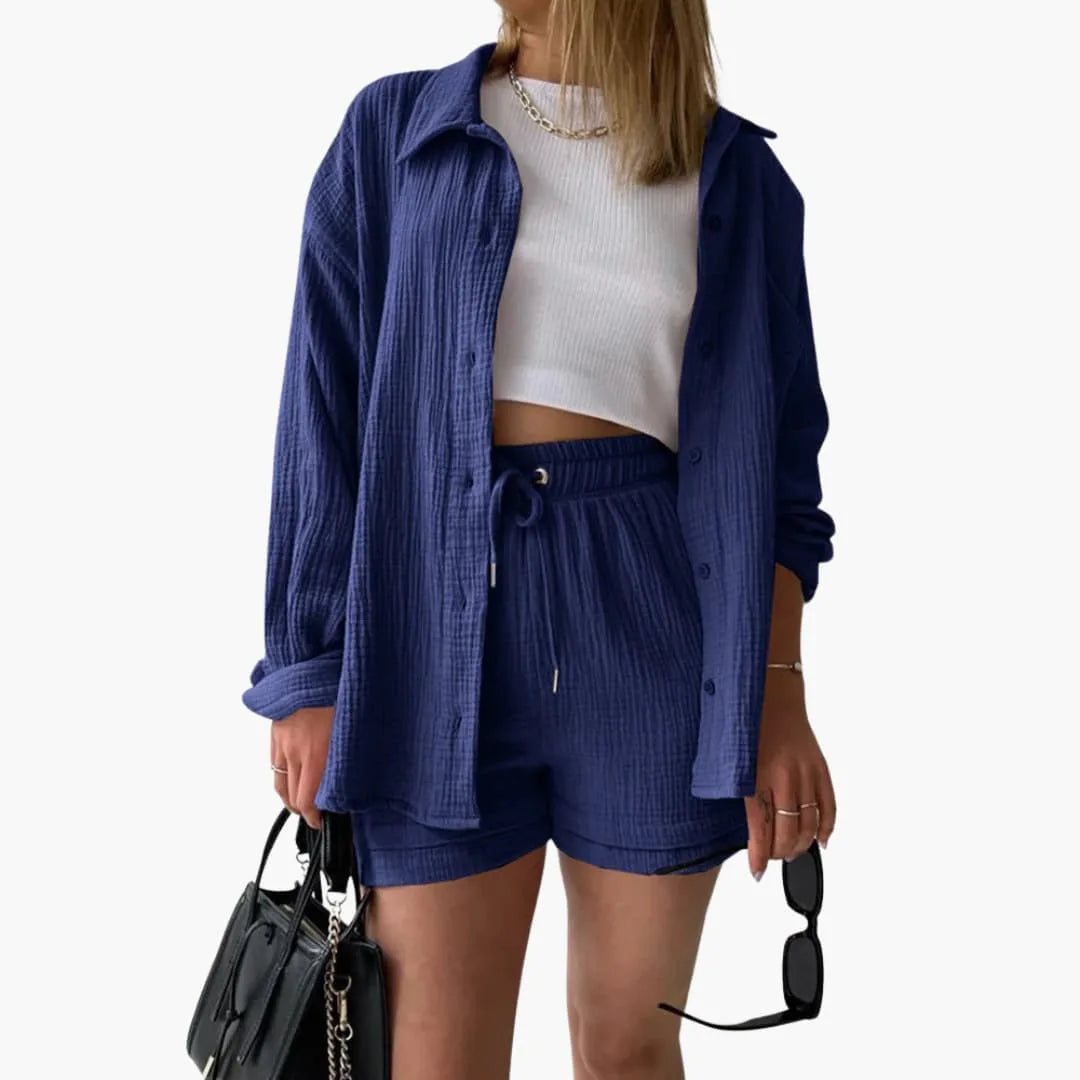 Model wearing a blue crinkle button-up shirt and matching shorts set
