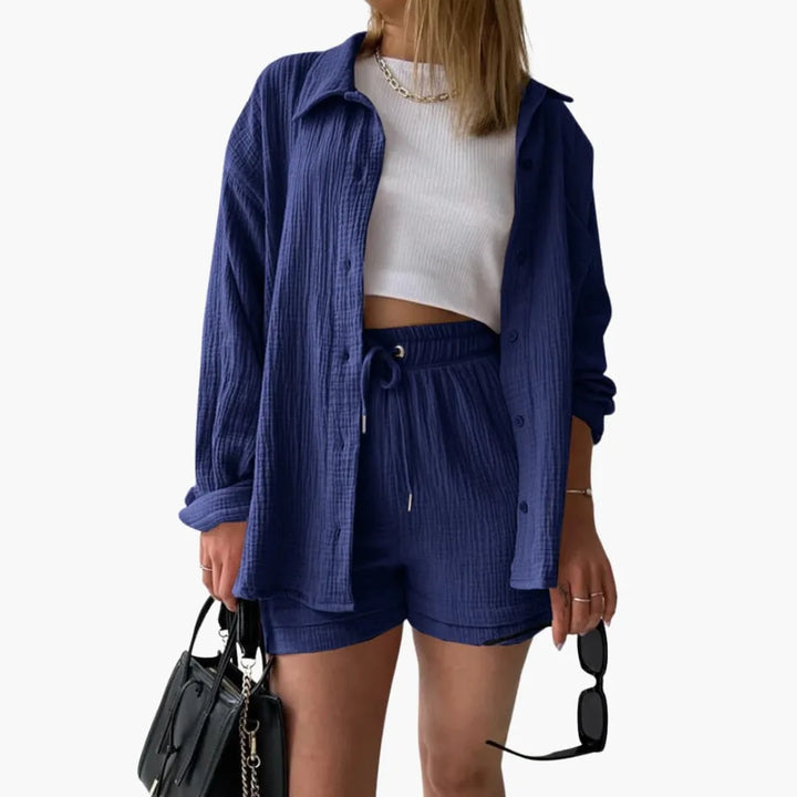 Model wearing a blue crinkle button-up shirt and matching shorts set