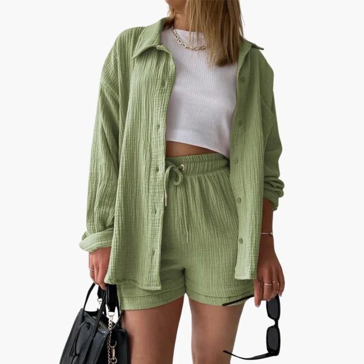 Model wearing a light green crinkle button-up shirt and matching shorts set