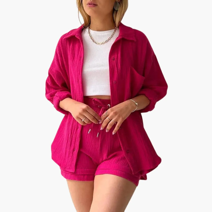 Model wearing a pink crinkle button-up shirt and matching shorts set