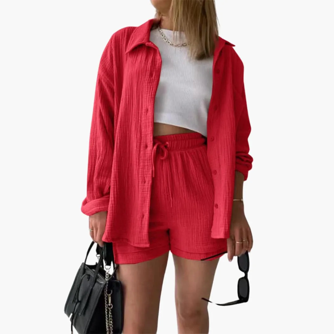Model wearing a red crinkle button-up shirt and matching shorts set