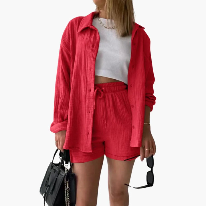 Model wearing a red crinkle button-up shirt and matching shorts set