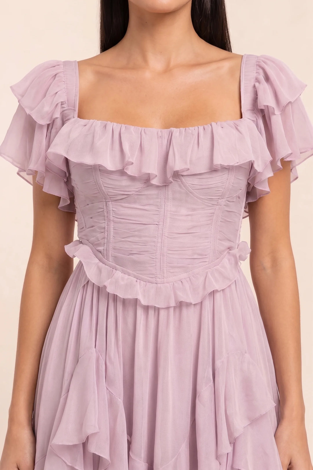 Close-up detail of pink ruffle corset midi dress bodice and skirt