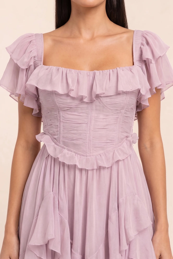 Close-up detail of pink ruffle corset midi dress bodice and skirt