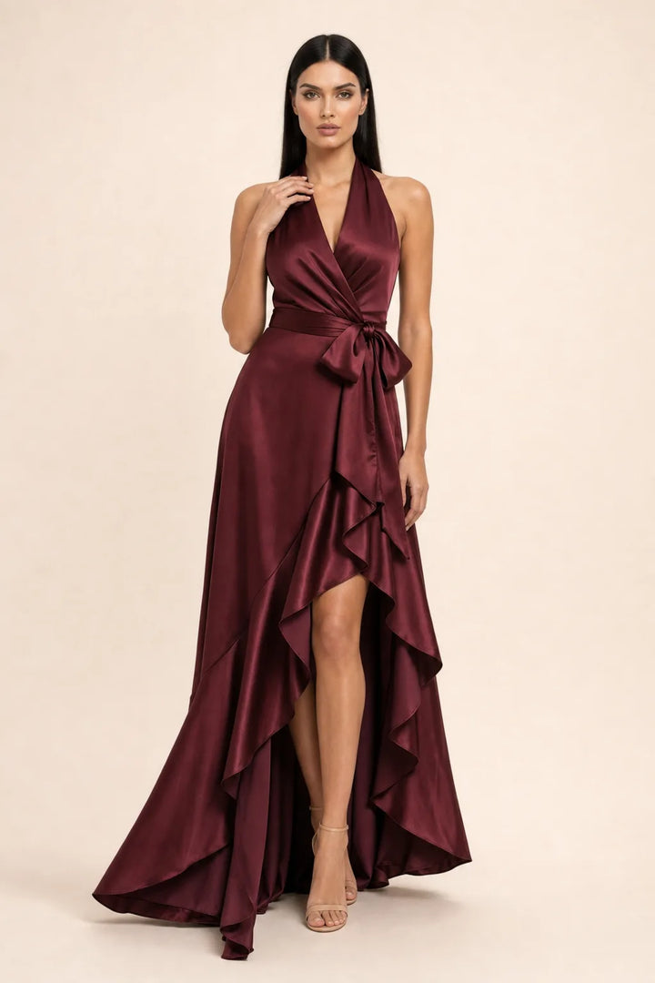 Burgundy satin halter wrap gown on model in contrapposto stance