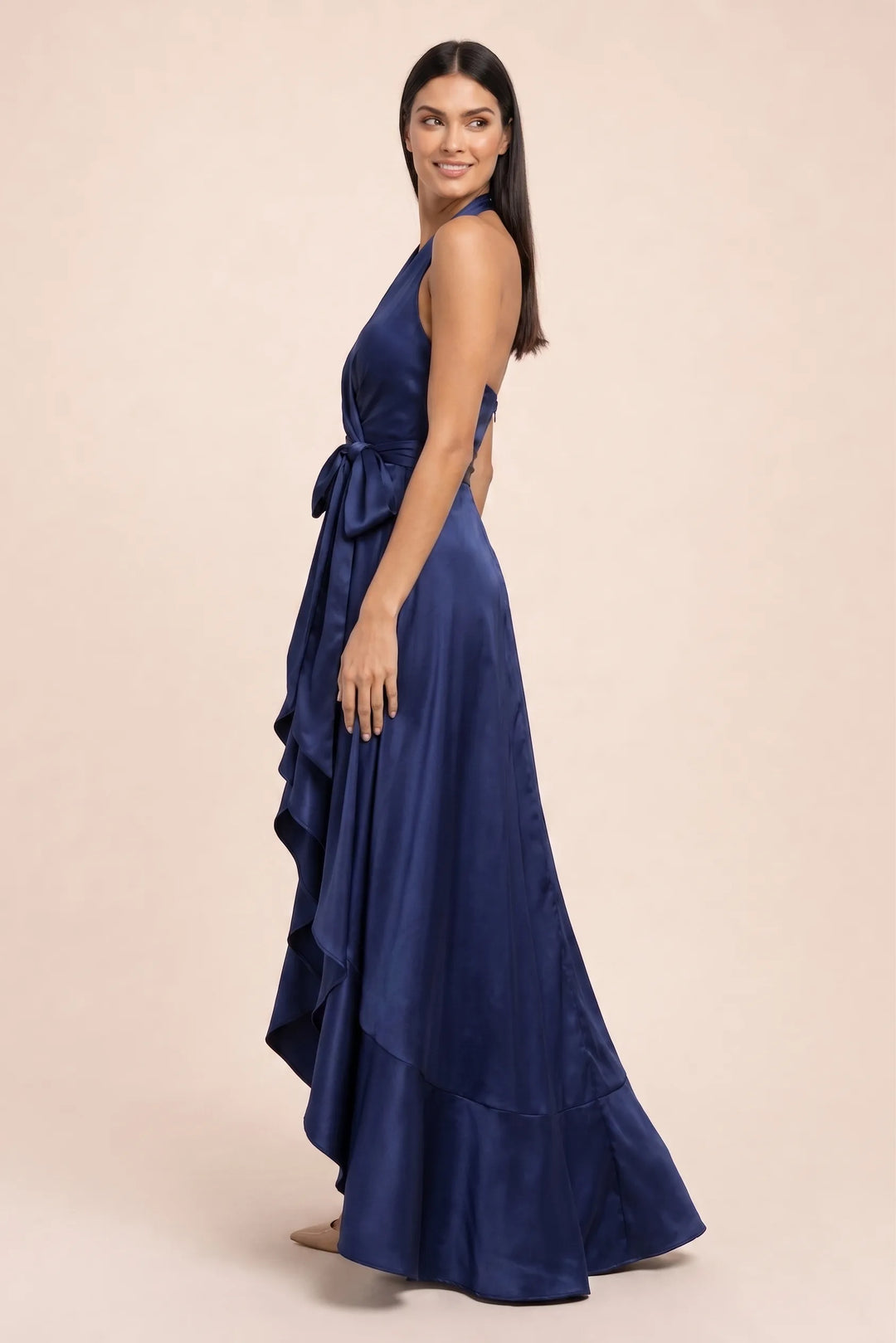 Navy blue satin halter wrap gown on model in three-quarter turn