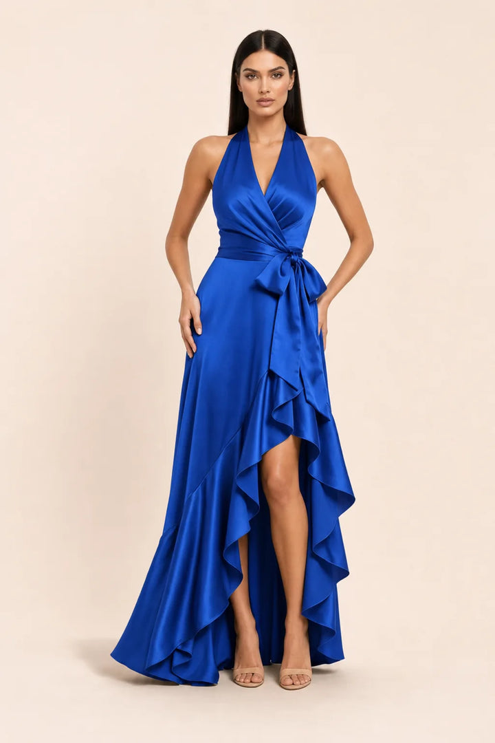 Royal blue satin halter wrap gown on model in contrapposto stance