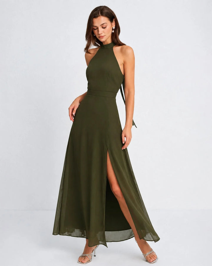 Woman in a floor-length green halter chiffon gown, facing forward
