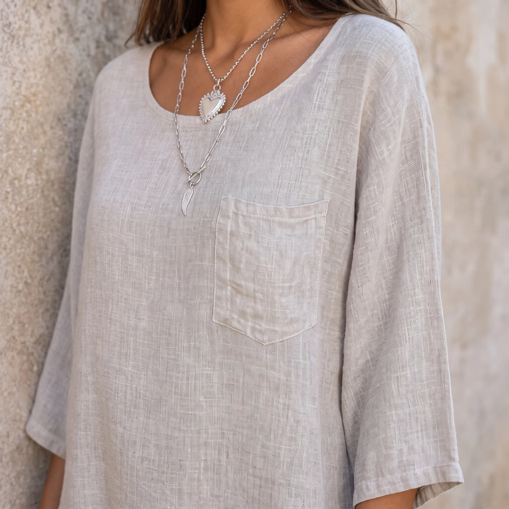Close-up detail of a relaxed apricot pocket top