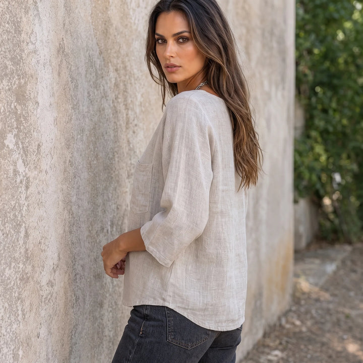 Relaxed apricot pocket top on a model in a three-quarter turn
