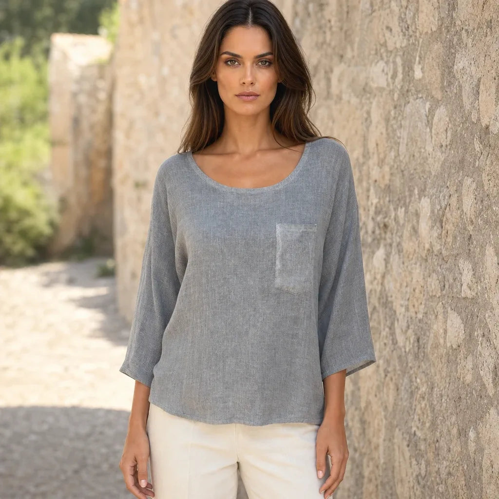 Relaxed gray pocket top on a model in a contrapposto stance