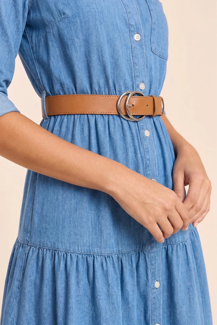 Close-up detail of tiered denim shirt dress in blue