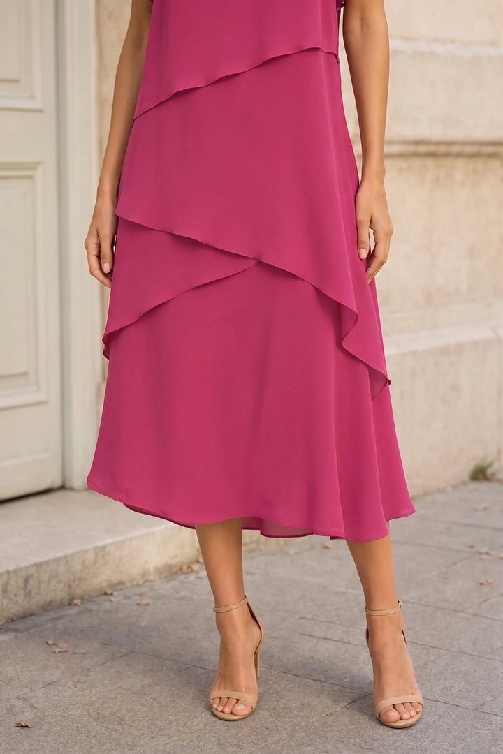 Close-up detail of a pink tiered chiffon midi dress