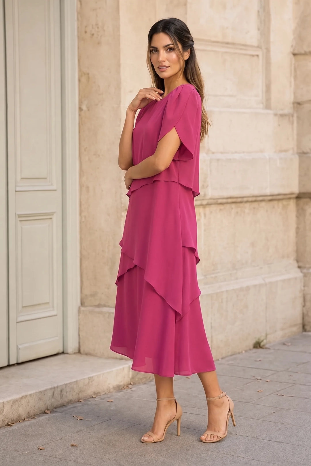 Pink tiered chiffon midi dress on a model in a three-quarter turn