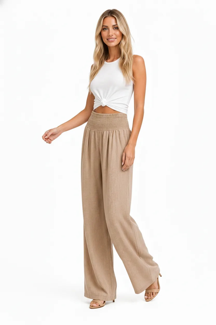 Khaki smocked wide-leg pants on a model in natural movement