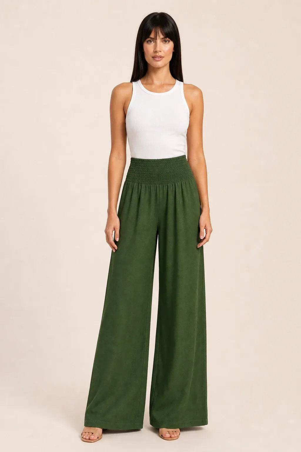 Army green smocked wide leg pants on model in contrapposto stance