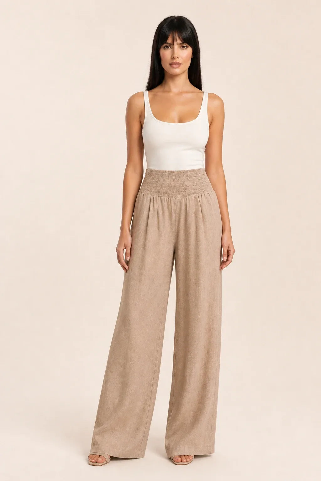 Khaki smocked wide leg pants on model in contrapposto stance