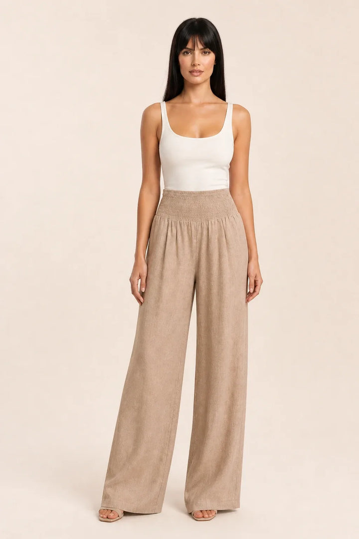 Khaki smocked wide leg pants on model in contrapposto stance