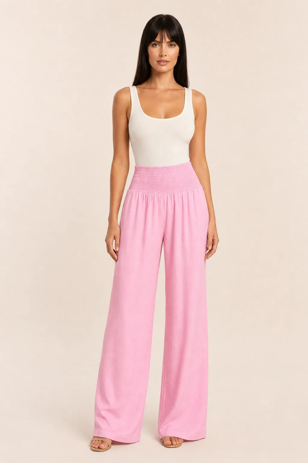 Pink smocked wide leg pants on model in contrapposto stance