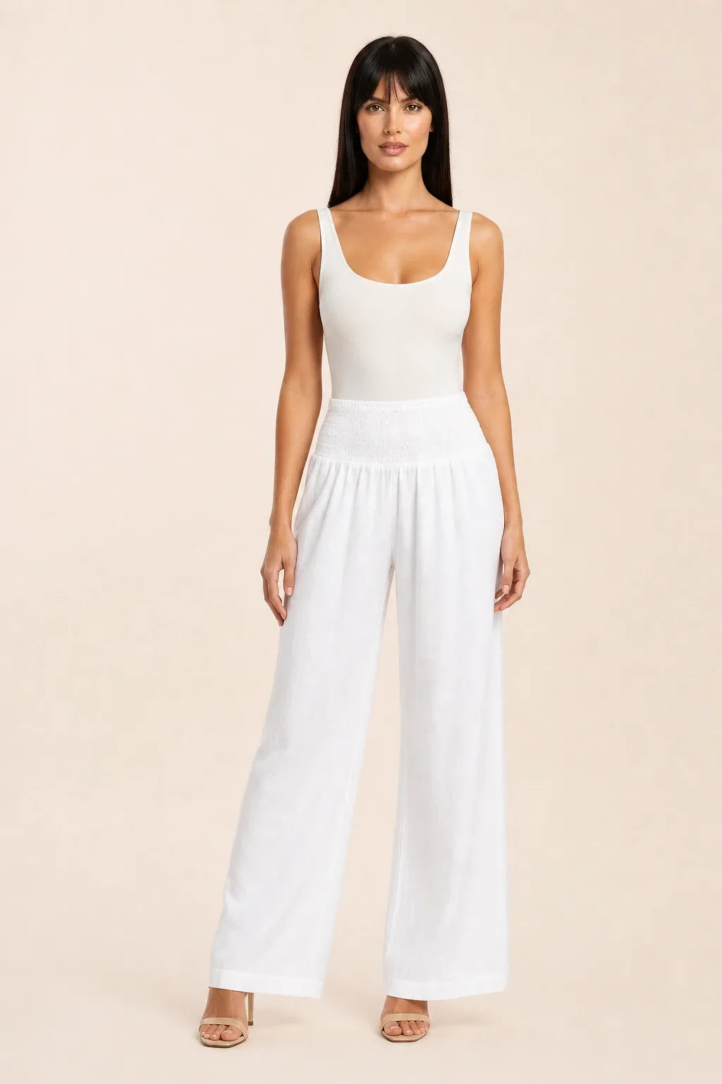 White smocked wide leg pants on model in contrapposto stance